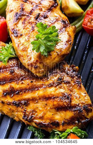Grilled chicken breast in different variations with cherry tomatoes, green French beans, garlic