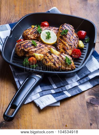 Grilled chicken breast in different variations with cherry tomatoes, green French beans, garlic, her