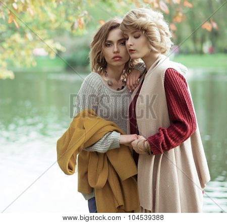 Young beautiful women near lake. Glamour fashion portrait.