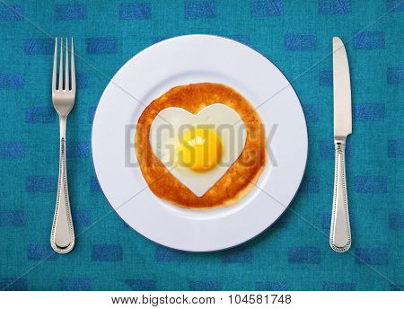 festive snack from scrambled egg on white plate with knife and fork