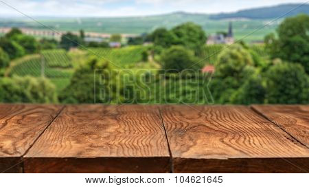Empty wooden table with vineyard landscape in France on background. Header for website