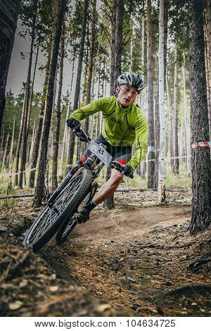 racer on mountain bike rides on a u-turn