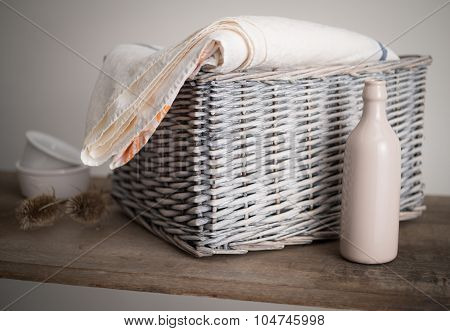 Wicker Basket With A Bottle, Plant And Cloth
