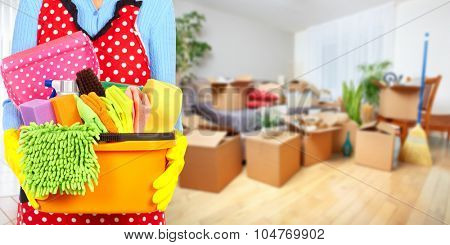 Maid hands with cleaning tools. House cleaning service concept.