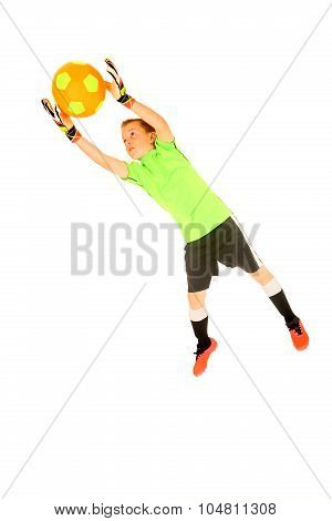 Young Boy Soccer Goalie Jumping To Save From Goal