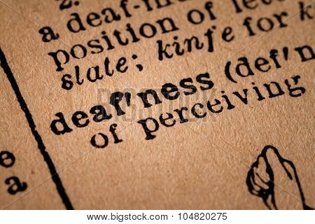 Close-up Of An Opened Dictionary Showing The Word Defness
