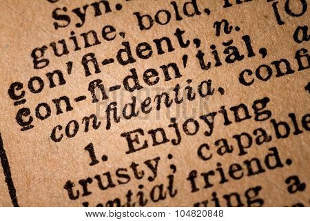 Close-up Of An Opened Dictionary Showing The Word Confidential