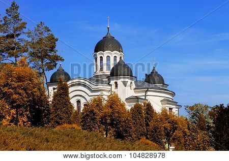 Curchi monastery among autumn trees and blue sky