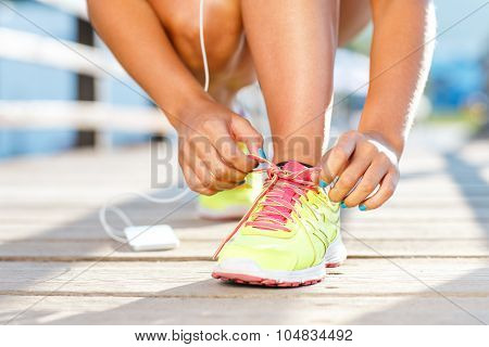 Running Shoes - Woman Tying Shoe Laces. Closeup Of Female Sport Fitness Runner Getting Ready For Jog