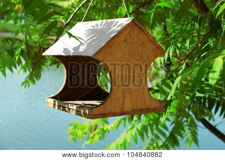 Bird feeder house with bird food, outdoor