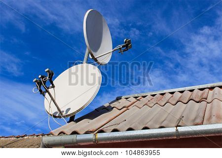 Two white satellite dish on the roof