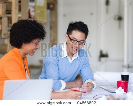 Two desingers working on a project together in office