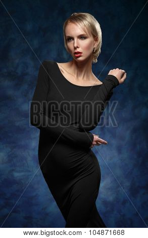 Portrait Of Sexy Blonde Woman In A Black Slinky Dress.