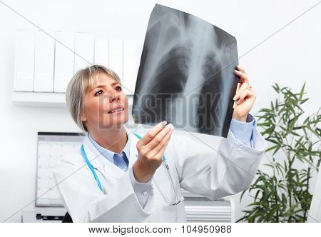 Mature medical doctor woman over hospital background.