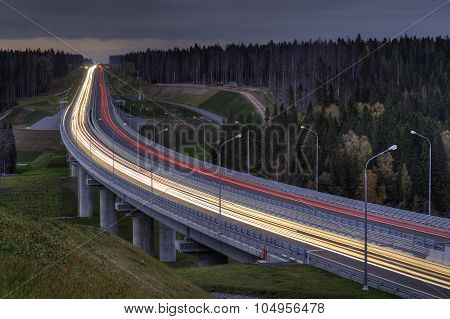 Light Trails On Four Lane Highway, Crosses The Night Forest.
