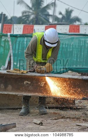 Construction workers cutting metal using blowtorch at the construction site