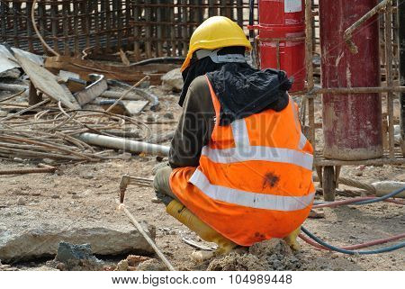 Construction workers cutting metal using blowtorch at the construction site