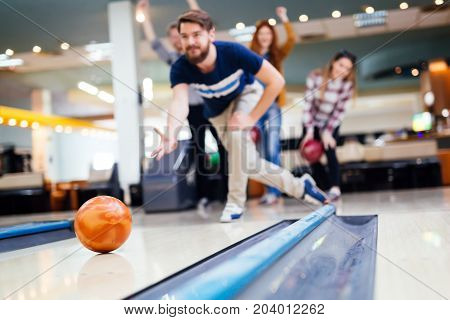 Friends having fun while bowling and speding time together