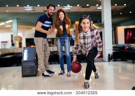 Friends having fun while bowling and speding time together