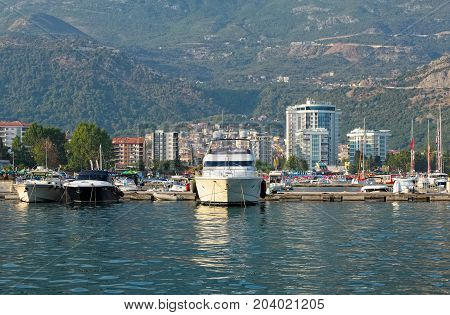 MONTENEGRO, BUDVA - AUGUST 8, 2017: View at the marina for yachts and boats and the town of Budva Budva Riviera resort