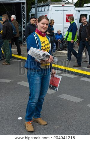BERLIN - MAY 01 2015: International Labour Day. Distributor of free newspapers.