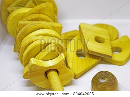 Handmade wooden pyramid toy with different shapes