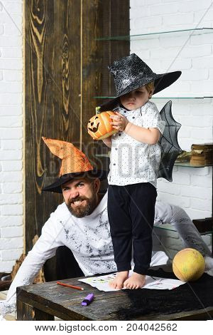 Witcher And Little Magician Make Halloween Decor. Man And Kid