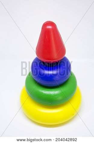 Cheap colored plastic pyramid toy on white background