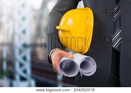 Business holding man helemet business success yellow solid