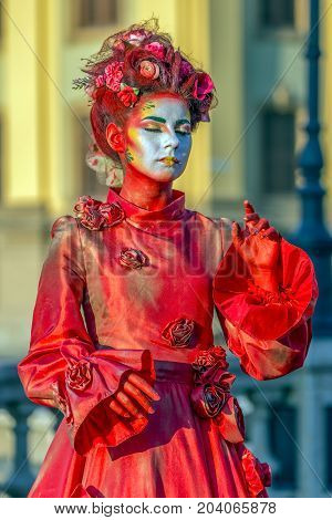 TIMISOARA ROMANIA - SEPTEMBER 8 2017: Portrait of living statue of a woman multicolor dressed and present on the street CheckART Carnival organized by the City Hall Timisoara. Union Square.