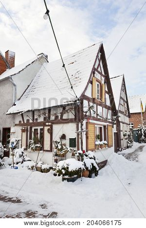 Old Half-timbered House In Snowy Village, Germany