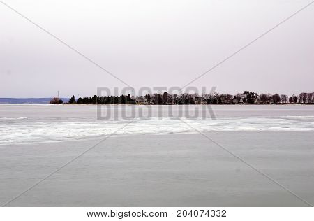 A view of ice-covered Little Traverse Bay, and Harbor Point, from the beach in Wequetonsing, Michigan, during March.