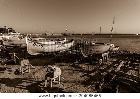 POMORIE BULGARIA - AUGUST 17 2017: Fishing boats on the shore. Seaport of the seaside town of Pomorie. Stzliyation. Sepia.
