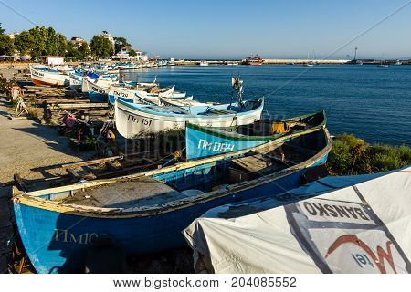 POMORIE BULGARIA - AUGUST 17 2017: Fishing boats on the shore. Seaport of the seaside town of Pomorie.