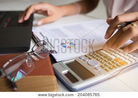 Businesswoman calculate about cost and doing finance at home office Finance managers task Concept business and finance investment
