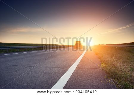 blurred car at high speed on the highway at sunrise