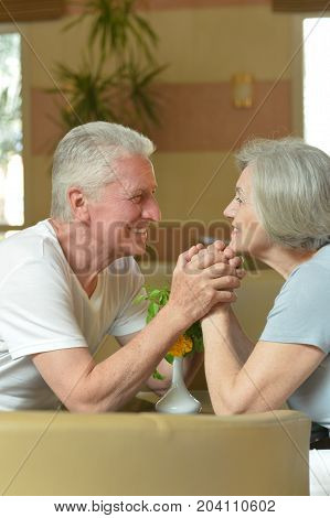Nice old couple resting in hotel hall