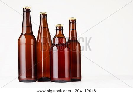 Collection brown bottles mockup. Template for advertising design branding identity on white wood table.