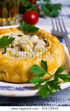 Round meat pie with vegetables and spices on a wooden background. Selective focus.
