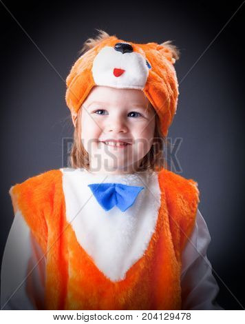 Little baby girl dressed in a fox suit . Closeup