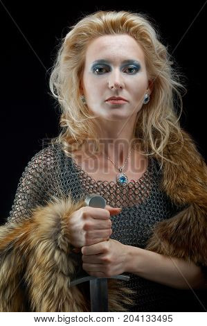 Valkyrie.Viking girl with sword , close up