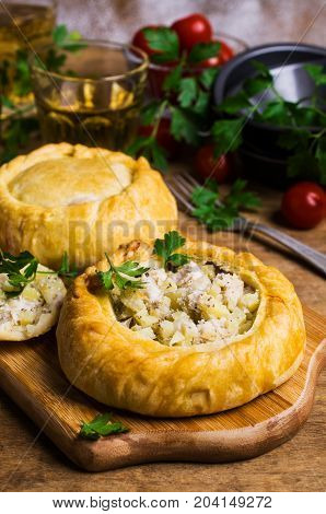 Round meat pie with vegetables and spices on a wooden background. Selective focus.