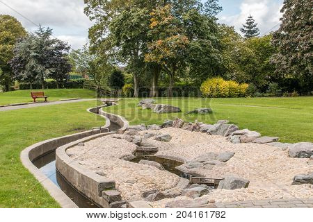 Swadlincote Park Derbyshire water and stone feature. water chanel rock feature with stone and pebble inlays.
