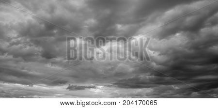 Panorama of a gray gloomy sky. Thunderclouds over horizon cloudscape storm.