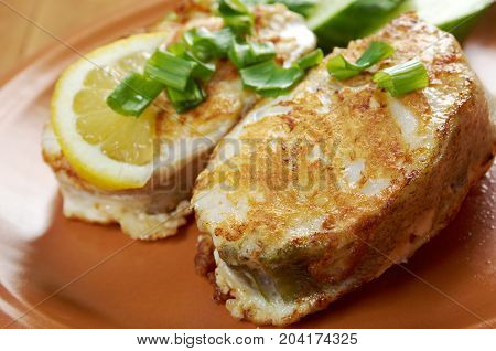 grilled t-bone codfish steak and vegetables close up homemade meal