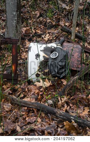 Scary authentic Russian gas mask with breathing hose abandoned in woods