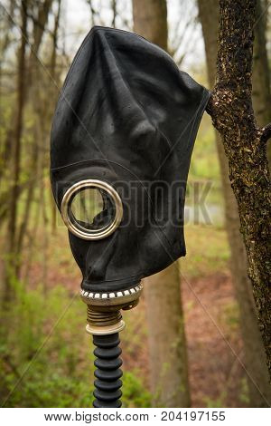 Scary authentic Russian gas mask with breathing hose abandoned in woods
