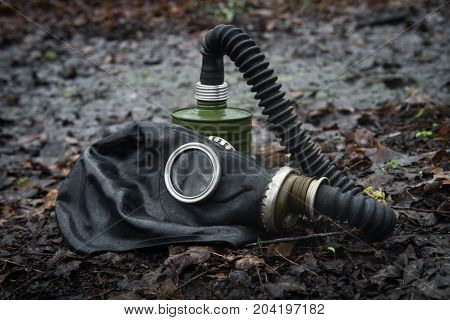 Scary authentic Russian gas mask with breathing hose abandoned in woods