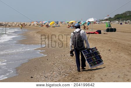 Poor Street Vendor Of Clothes And Dresses Along The Beach
