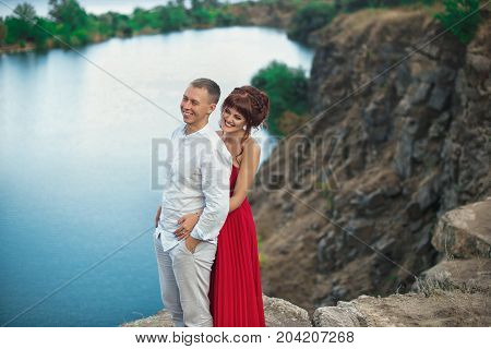Couple Hiking In Mountains Landscape. Woman And Man Standing On Hike